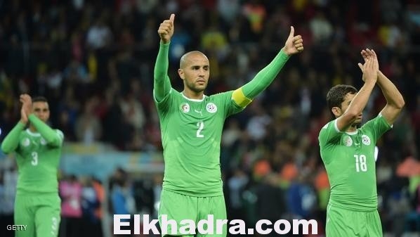 Algeria's defender and captain Madjid Bougherra (C) and Algeria's forward Abdelmoumene Djabou (R) gesture to the crowd after losing their Round of 16 football match against Germany following extra-time at Beira-Rio Stadium in Porto Alegre during the 2014 FIFA World Cup on June 30, 2014. AFP PHOTO / GABRIEL BOUYS        (Photo credit should read GABRIEL BOUYS/AFP/Getty Images)