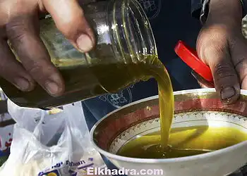 JIT, WEST BANK - OCTOBER 30:  Palestinian woman Amna a-Sakhen prepares a harvest meal, including a bowl of fresh olive oil, for her family and for Israeli human rights activists who are helping them harvest olives in a grove October 30, 2006 between her family's village of Jit and the militant Israeli settlers' outpost of Havat Gilad in the West Bank. Several hundred Israeli volunteers are helping Palestinians all over the West Bank harvest  their olives at the height of the season, in the belief that their presence deters the worst excesses of radical violence from militant right-wing settlers. Right-wing settlers have cut down and burnt groves, attacked farmers and stolen olives in recent years.  (Photo by David Silverman/Getty Images)