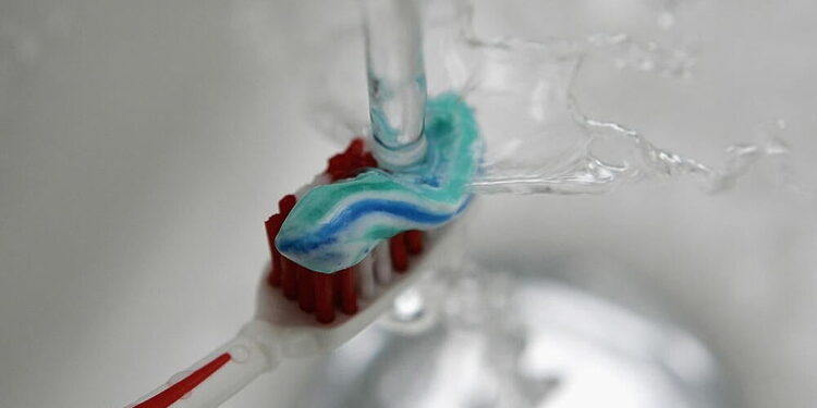 SCHWELM, GERMANY - JANUARY 10:  Water pours onto a toothbrush with toothpaste on January 10, 2007 in Schwelm, Germany.  (Photo Illustration by Christof Koepsel/Getty Images)