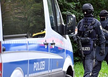 Policemen of a special unit are pictured at the Yorckgebiet district of Chemnitz, eastern Germany, where German police commandos hunting a fugitive Syrian bomb plot suspect raided a flat on October 9, 2016.  
Security was stepped up at airports and train stations as it was unclear whether the fugitive, Jaber Albakr, 22, was carrying more bomb-making material or weapons. Albakr had narrowly escaped police commandos at dawn on October 8, 2016 as they prepared to arrest him in his flat in the eastern city of Chemnitz, about 260 kilometres (160 miles) south of Berlin. / AFP / dpa / Hendrik Schmidt / Germany OUT        (Photo credit should read HENDRIK SCHMIDT/AFP/Getty Images)