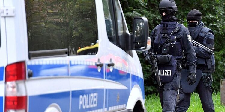Policemen of a special unit are pictured at the Yorckgebiet district of Chemnitz, eastern Germany, where German police commandos hunting a fugitive Syrian bomb plot suspect raided a flat on October 9, 2016.  
Security was stepped up at airports and train stations as it was unclear whether the fugitive, Jaber Albakr, 22, was carrying more bomb-making material or weapons. Albakr had narrowly escaped police commandos at dawn on October 8, 2016 as they prepared to arrest him in his flat in the eastern city of Chemnitz, about 260 kilometres (160 miles) south of Berlin. / AFP / dpa / Hendrik Schmidt / Germany OUT        (Photo credit should read HENDRIK SCHMIDT/AFP/Getty Images)